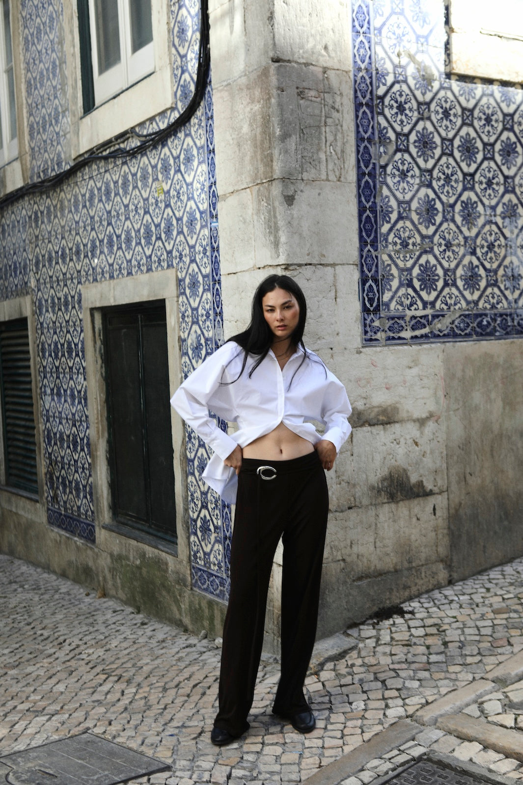 girl wearing button up shirt and brown pants