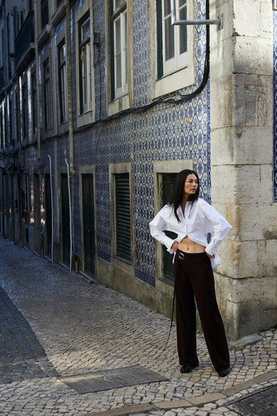 girl wearing button up shirt and brown pants