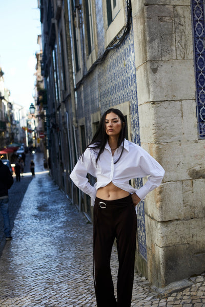 girl wearing button up shirt and brown pants