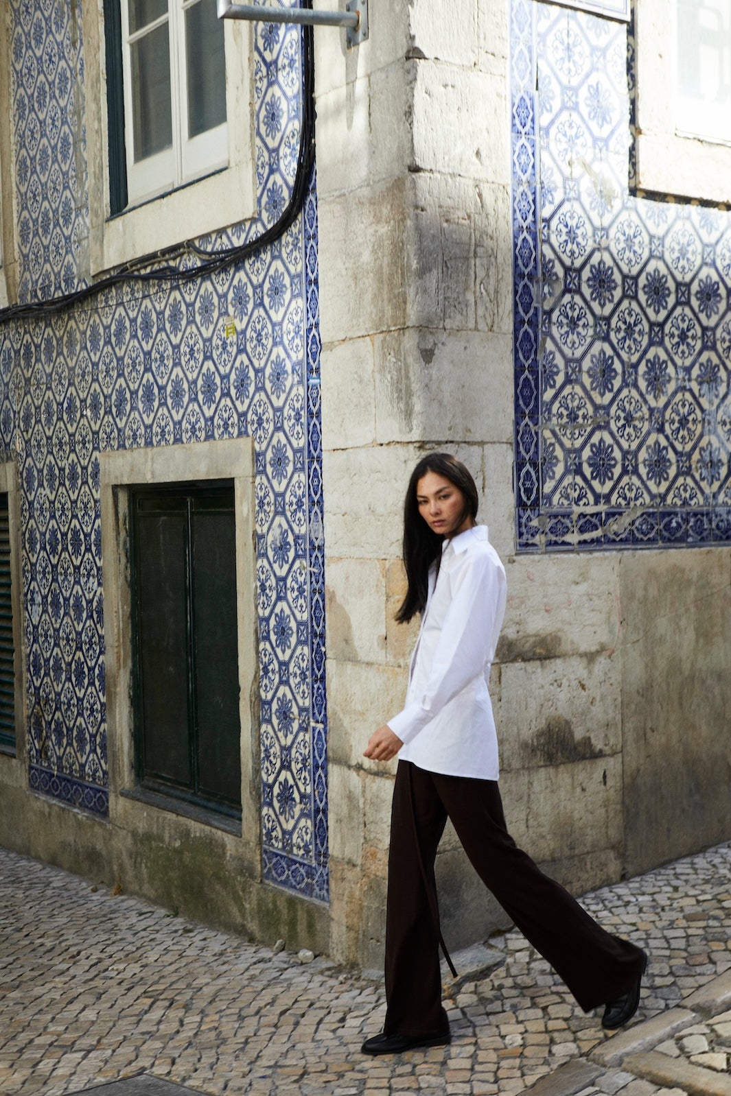 girl wearing button up shirt and brown pants