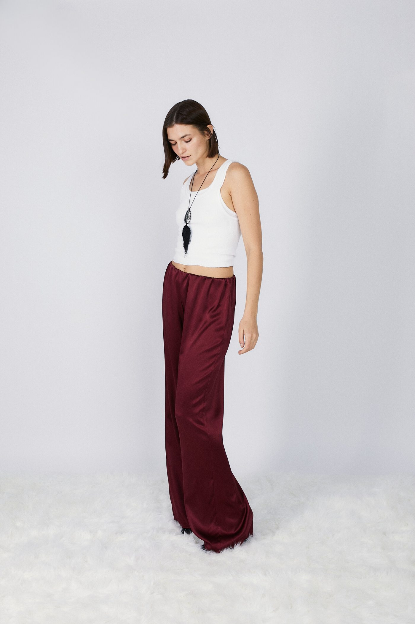 girl wearing roma silk pants in wine