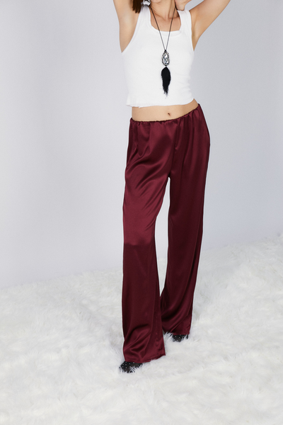 girl wearing roma silk pants in wine