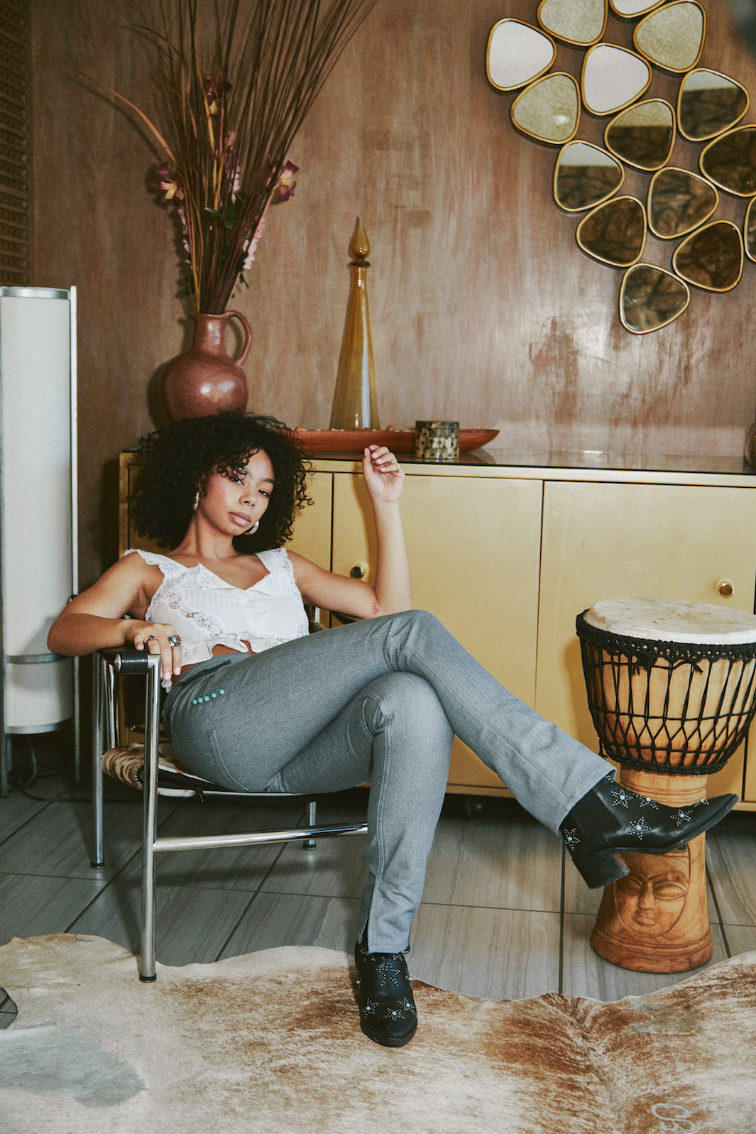 girl sitting down wearing mizawe santa fe pant in grey with turquoise studs