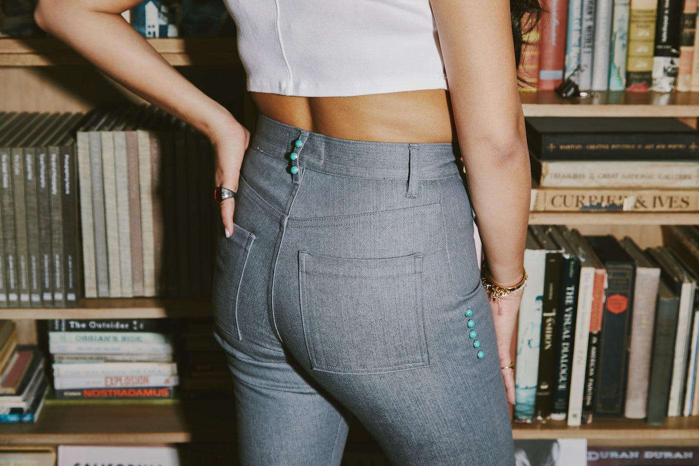 girl standing up wearing mizawe santa fe pant in grey with turquoise studs